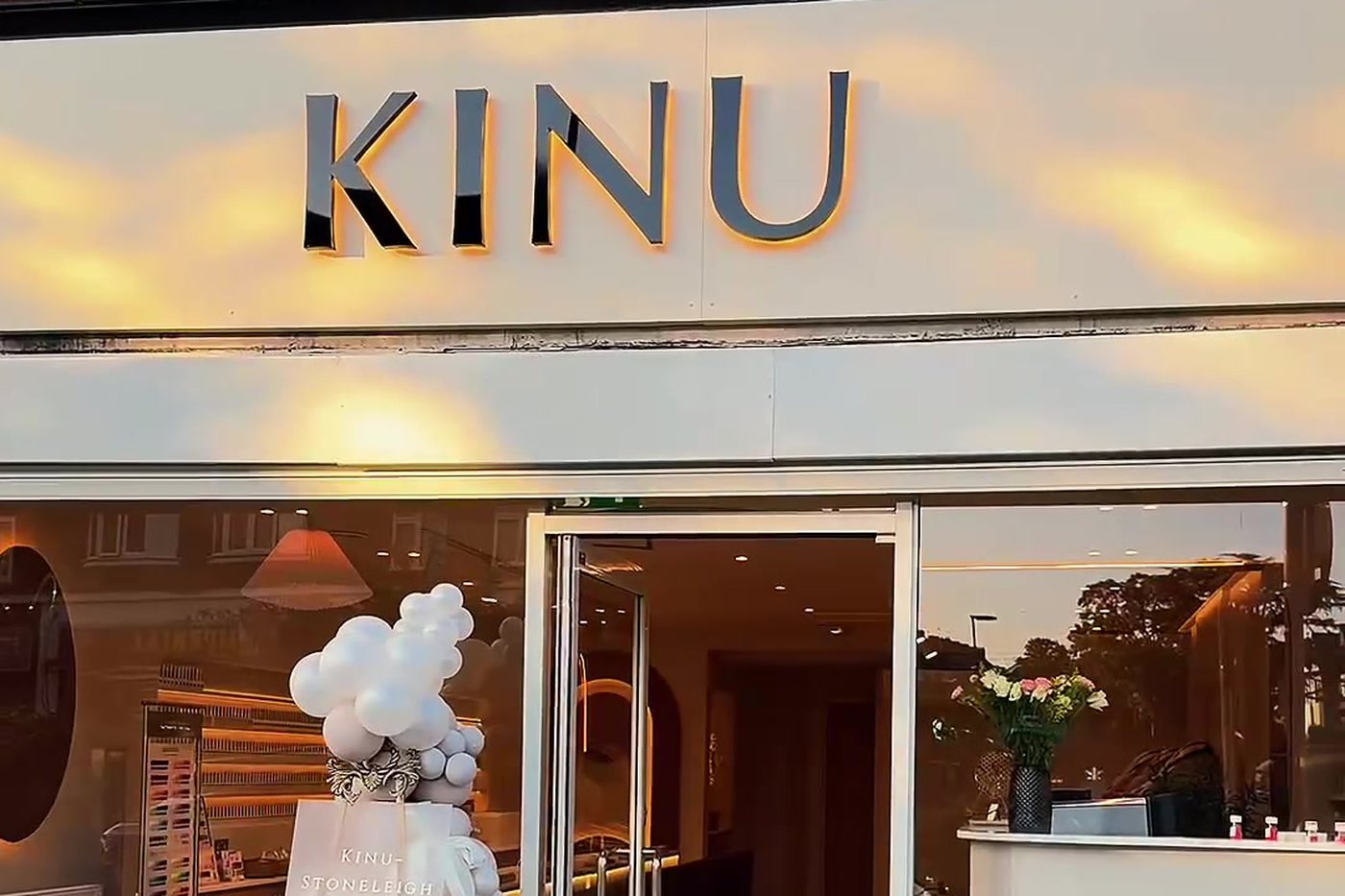 The KINU shopfront on Stoneleigh Broadway — dark lettering on a white fascia above glass doors